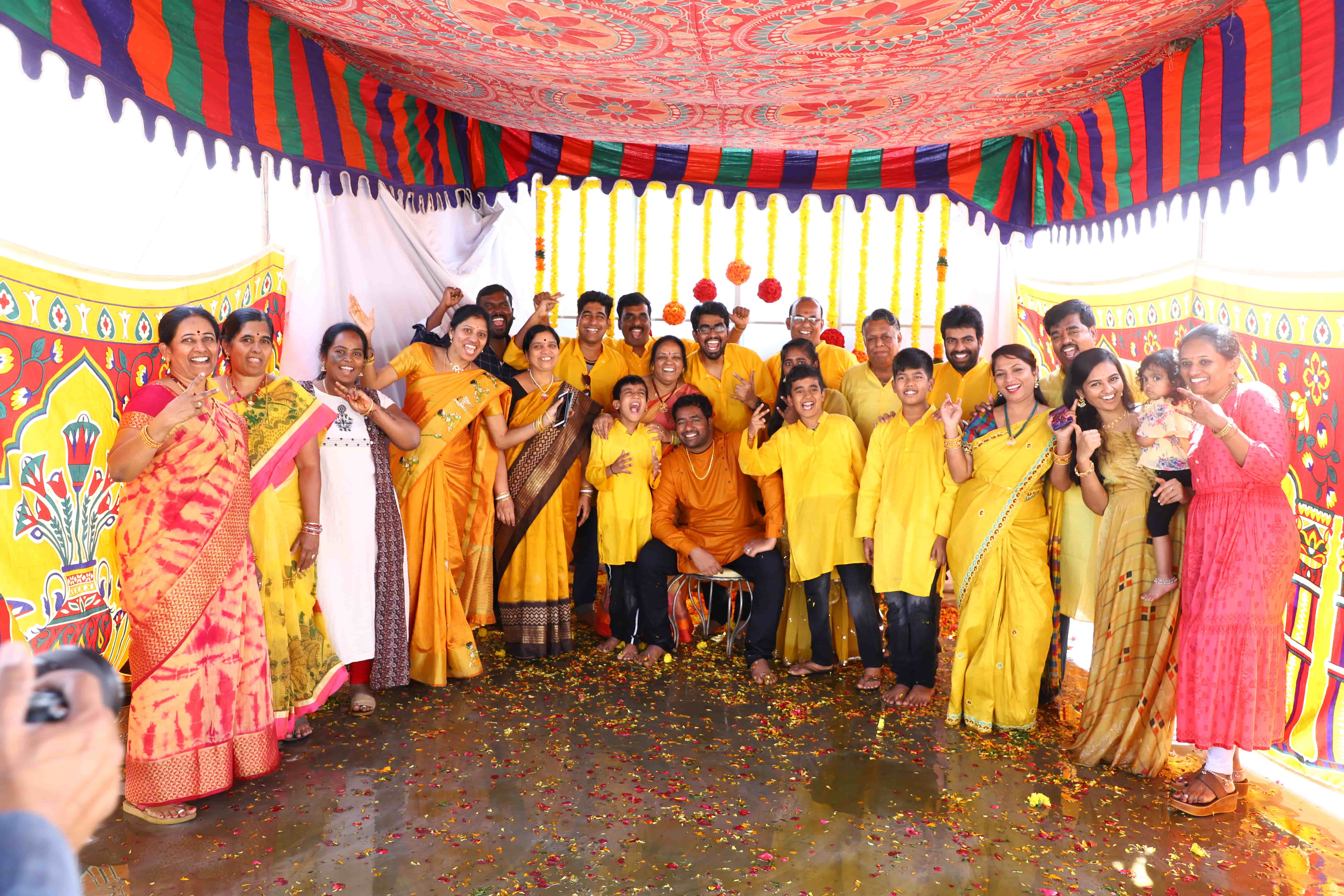haldi ceremony group family photo Hyderabad traditional yellow outfits celebration